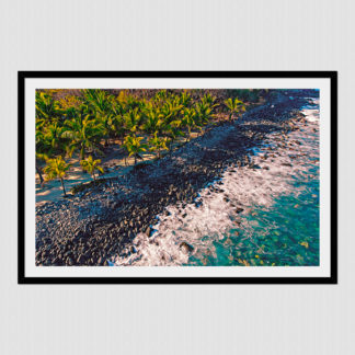 Aerial shot of palm trees and tiki hut on a rocky shoreline at Gatos Point in Zihuatanejo, Mexico.