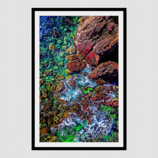 Waves and sun reflection on colorful rocks in Tenacatita, Mexico