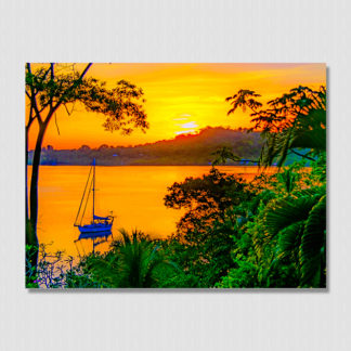 Iconic golden sunset and sailboat with oil paint effect in the calm Dolphin Bay, Bocas Del Toro, Panama