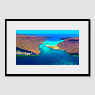 Aerial view of where desert cliffs meet the sandy seaway between two islands at Espiritu Santo, Baja, Mexico