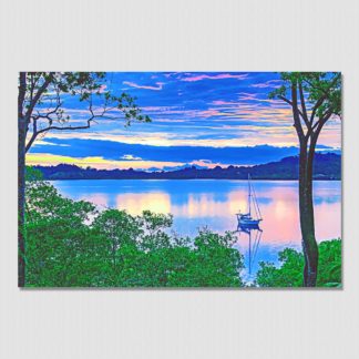 Iconic view of sailboat anchored on a glass calm bay in the jungles of Dolphin Bay, Bocas Del Toro, Panama