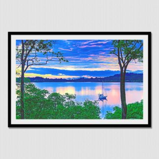 Iconic view of sailboat anchored on a glass calm bay in the jungles of Dolphin Bay, Bocas Del Toro, Panama