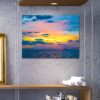 Distant schooner ship with colorful spectrum sky and cloud formations