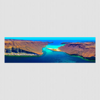 Aerial view of where desert cliffs meet the sandy seaway between two islands at Espiritu Santo, Baja, Mexico