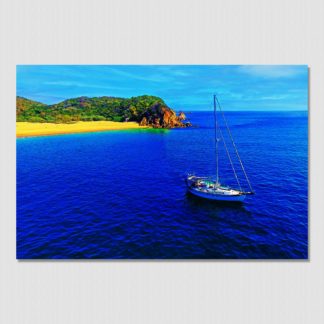 Living the dream on a sailboat anchored near paradise island beach cove with oil paint effect.