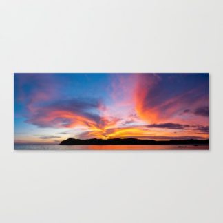 Stunning clouds illuminated by the setting sun behind the island mountains in Boca Chica, Panama