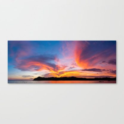 Stunning clouds illuminated by the setting sun behind the island mountains in Boca Chica, Panama