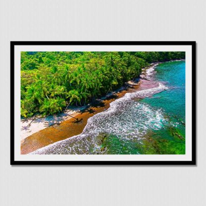 Aerial shot of palm trees and waves foaming on a deserted jungle beach at Coiba Park Island, Panama. Unique visual enhancements comprising of natural oil paint effect.