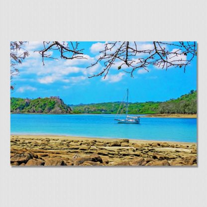 Sailboat floating in the distance with tree fringed frame and rocky beach, with oil paint effect. Photo was taken in Las Perlas Islands, Pacific Panama.