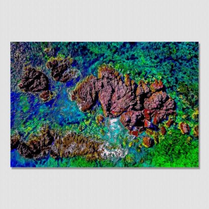 Low shot aerial view of colorful rocks and reefs from a clear water paradise at Tenacatita, Mexico.